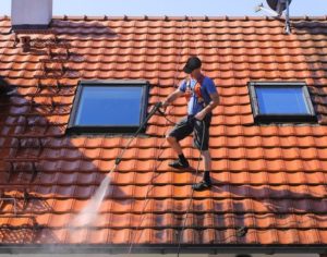 man cleaning roof