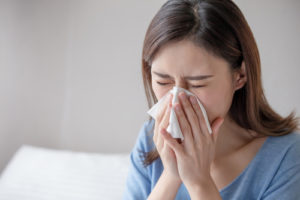 woman sneezing