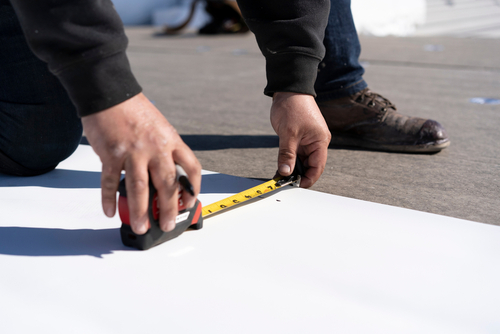 Man measuring roof