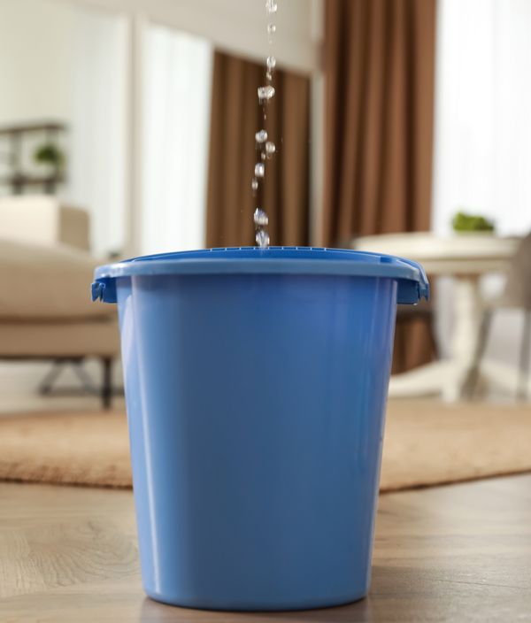 Bucket catching water from leaking roof in Tennessee