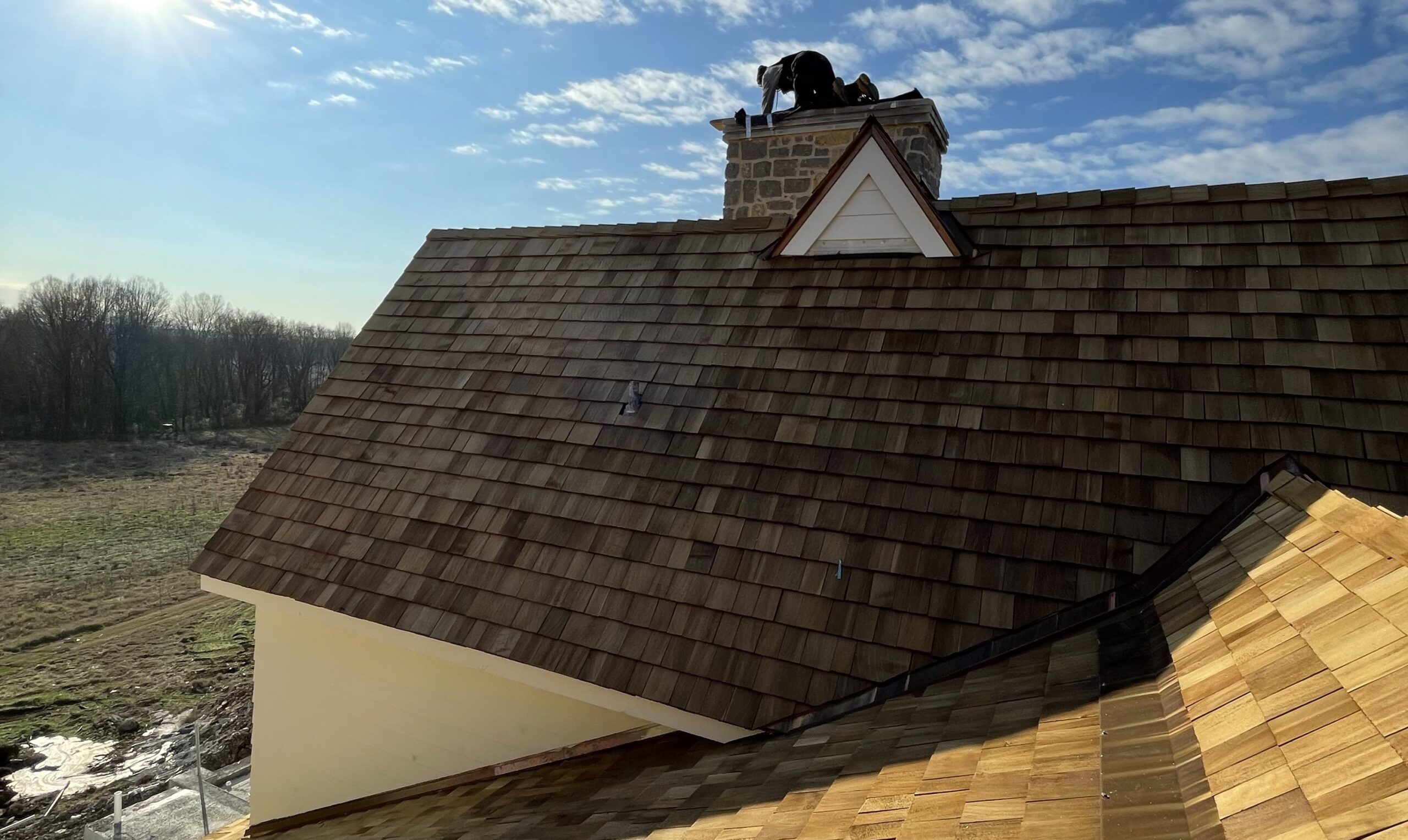 Man inspecting Roof near chimney