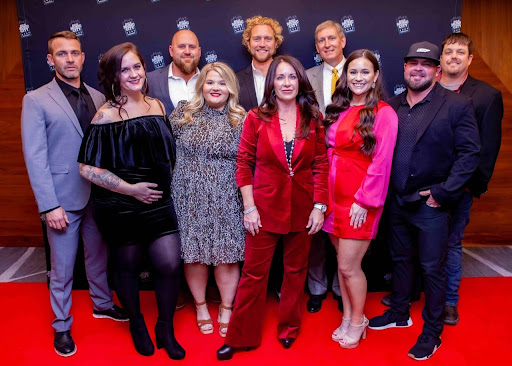 Group of people posing at a formal event. Penny GAF